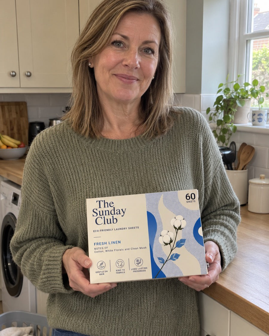 A member holding a box of The Sunday Club Fresh Linen laundry sheets