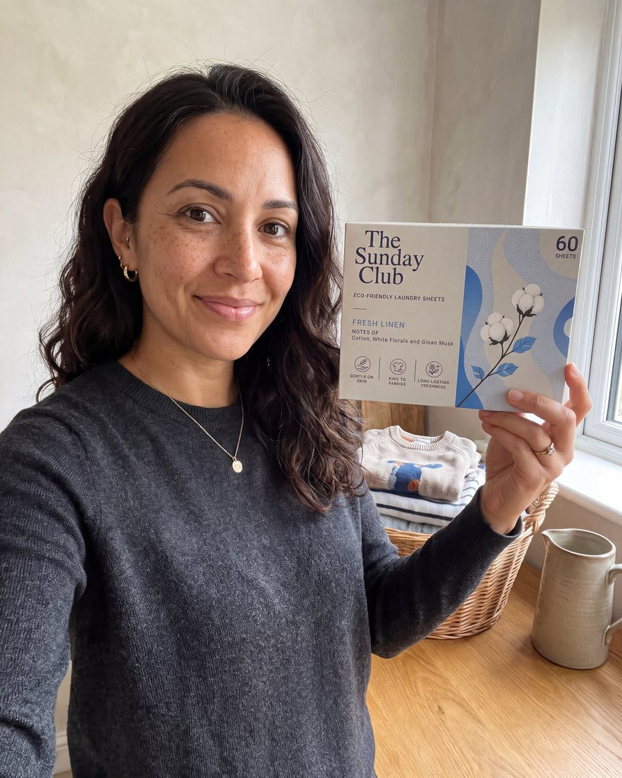 A member holding a box of The Sunday Club Fresh Linen laundry sheets