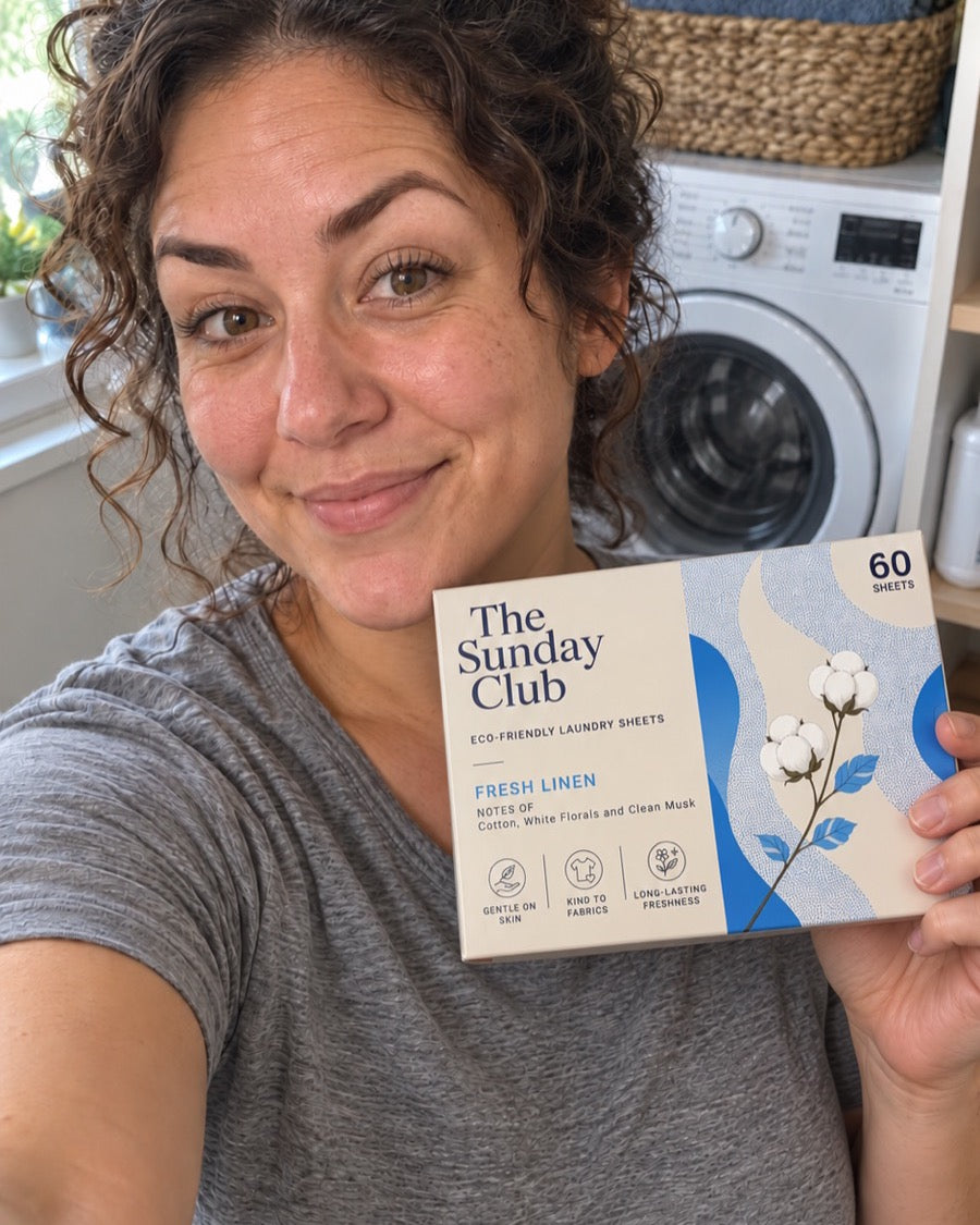 A member holding a box of The Sunday Club Fresh Linen laundry sheets